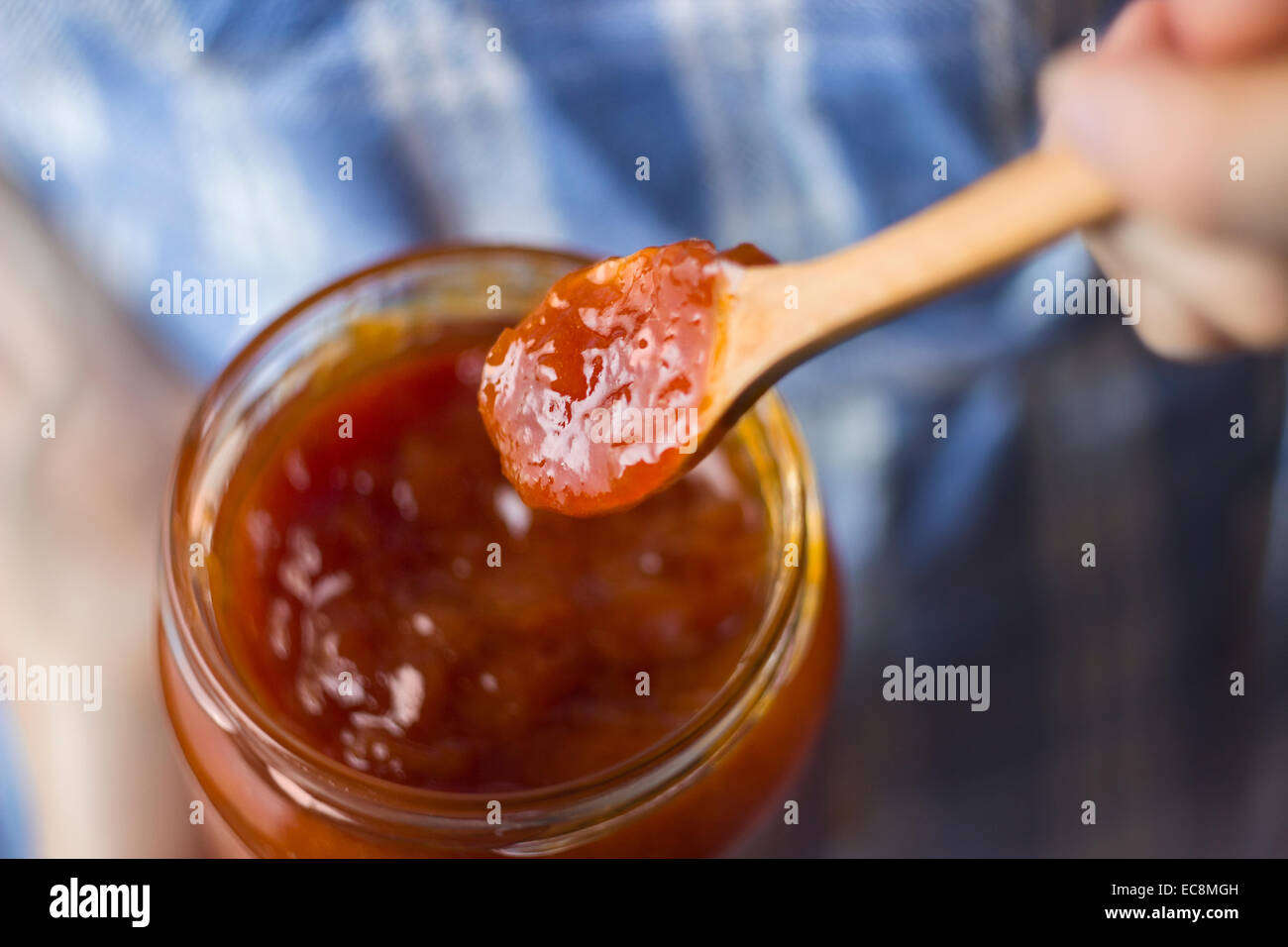 Hands holding jar of tasty organic apricot jam Stock Photo Alamy