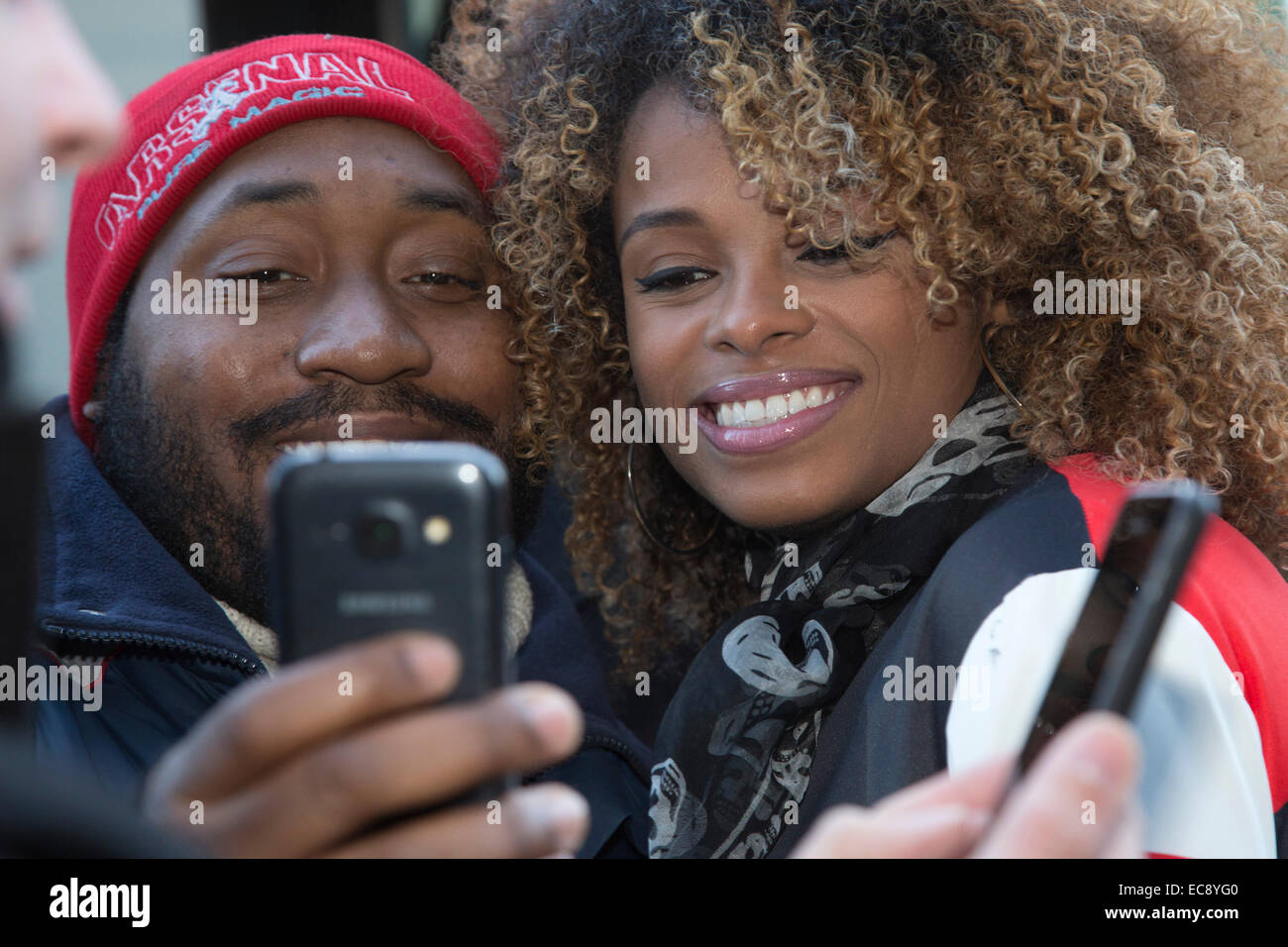 Fleur East has a selfie taken with a fan. X Factor Homecoming for singer Fleur East. Fleur East, X Factor 2014 finalist, arrives on her Battle Bus at the MTV studios in Hawley Crescent, Camden Town. Stock Photo
