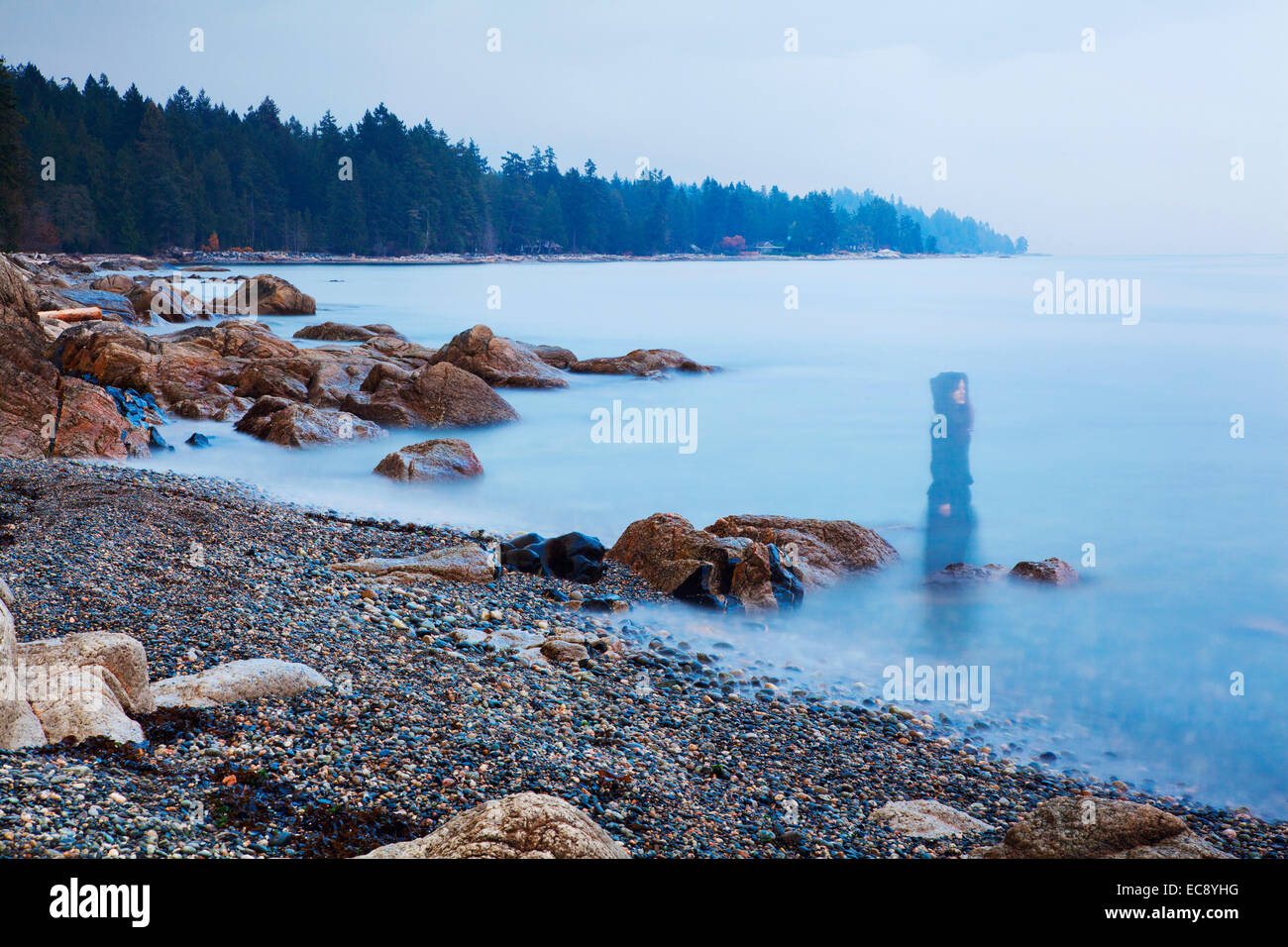 Long exposure of a ghostly image of woman on the beach in Sechelt, BC, Canada Stock Photo