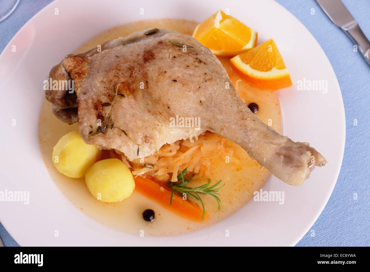 Duck leg with braised cabbage, potato and gravy, top view, close up Stock Photo