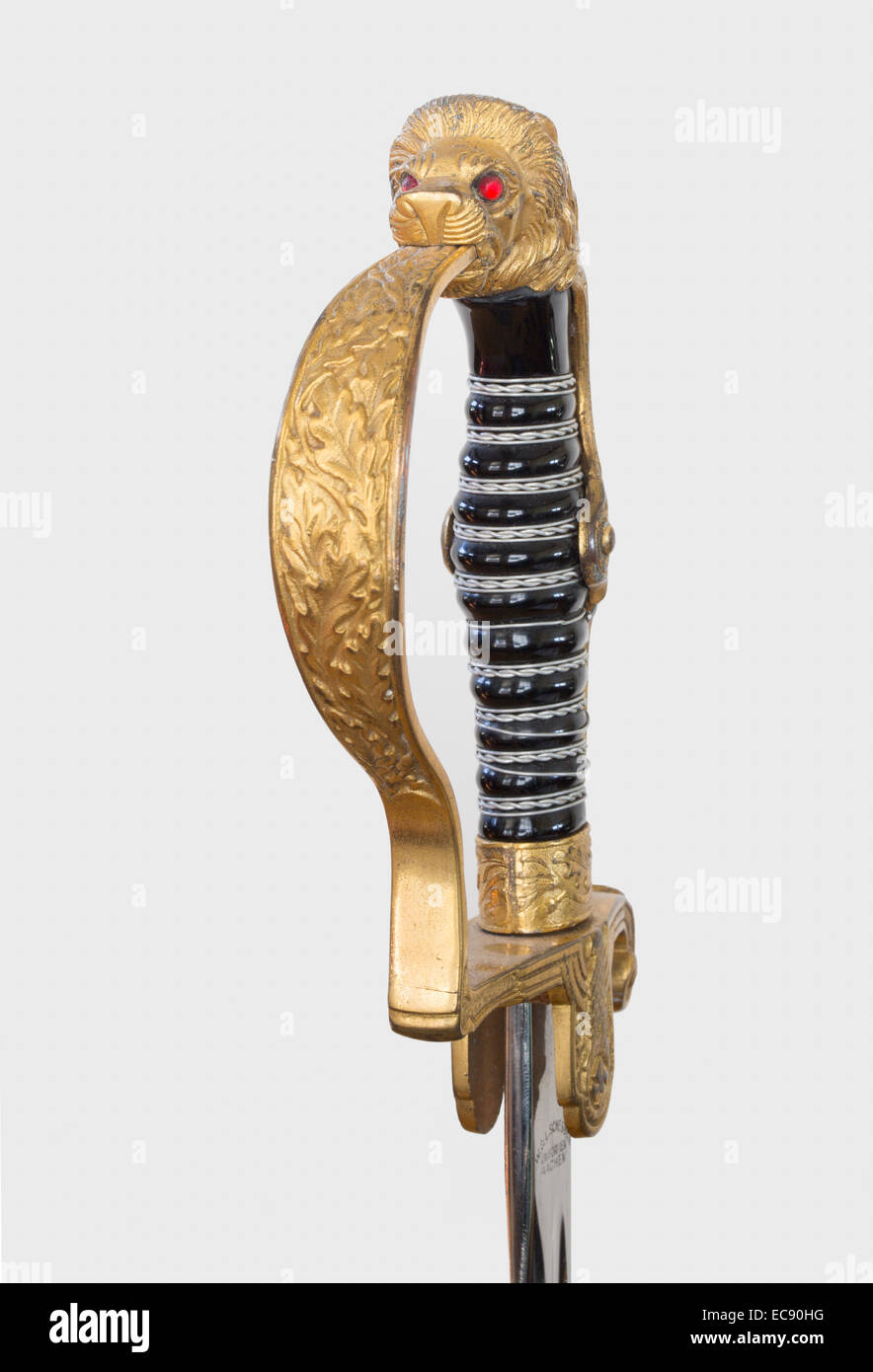 Close up detail of a 1940s WWII Nazi military army dress sword with a lion's head pommel with red glass eyes. Stock Photo