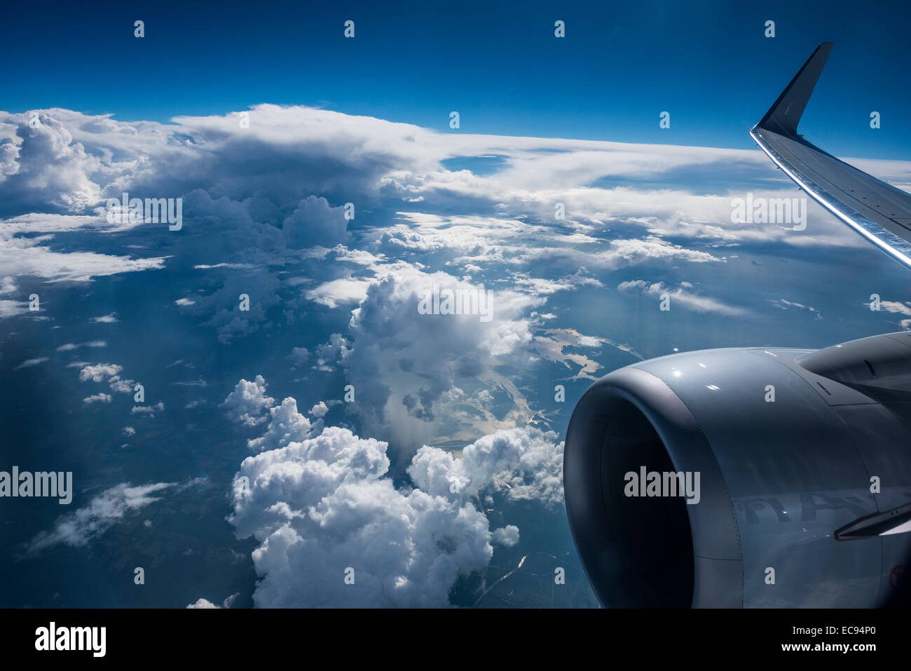 plane flying america usa airport aerial view window clouds high altitude 30 000 ft Stock Photo