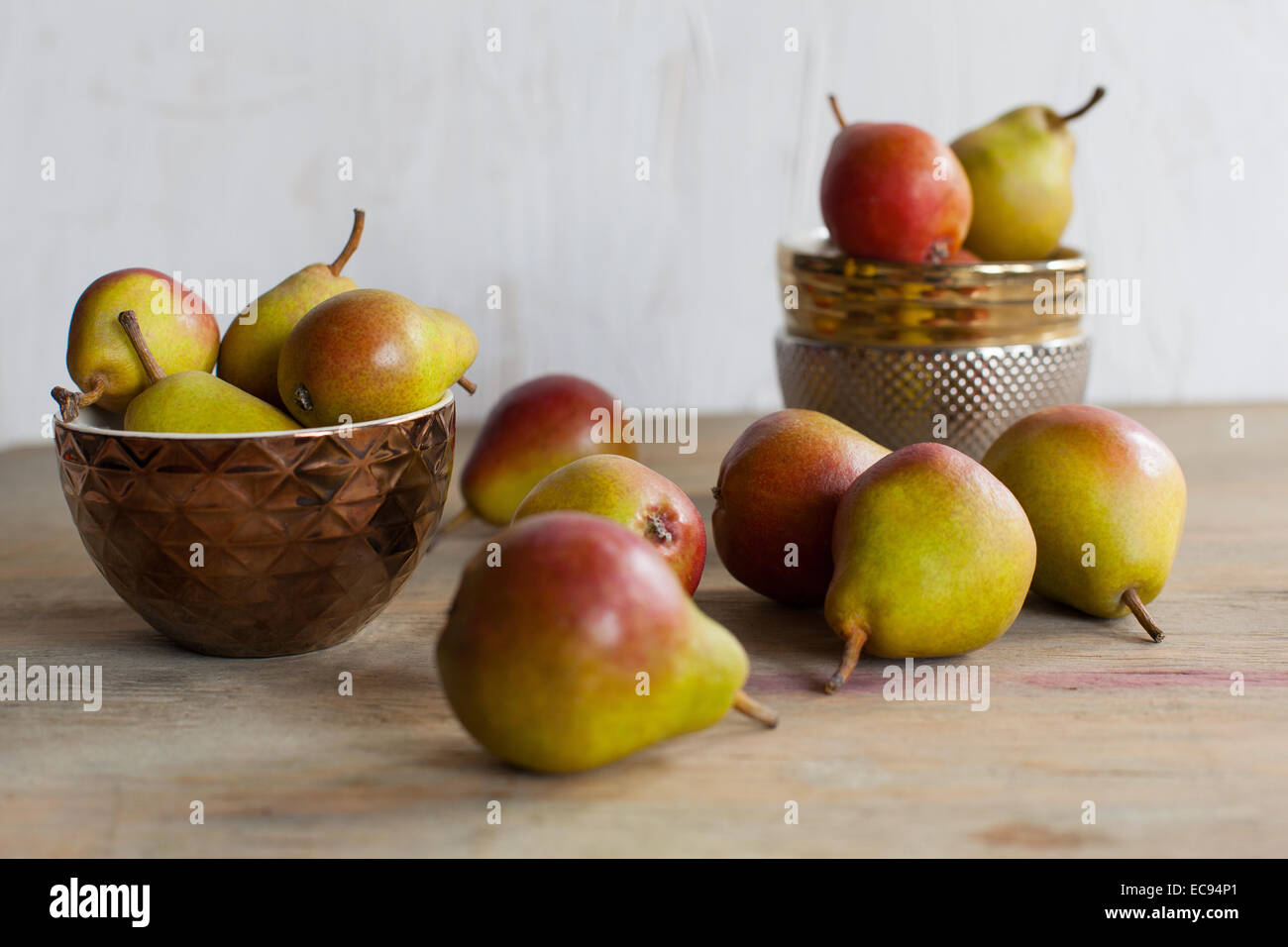 Still life of pears and metal bowls Stock Photo