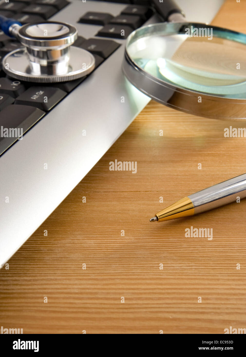 stethoscope and keyboard with pen on wooden table Stock Photo - Alamy