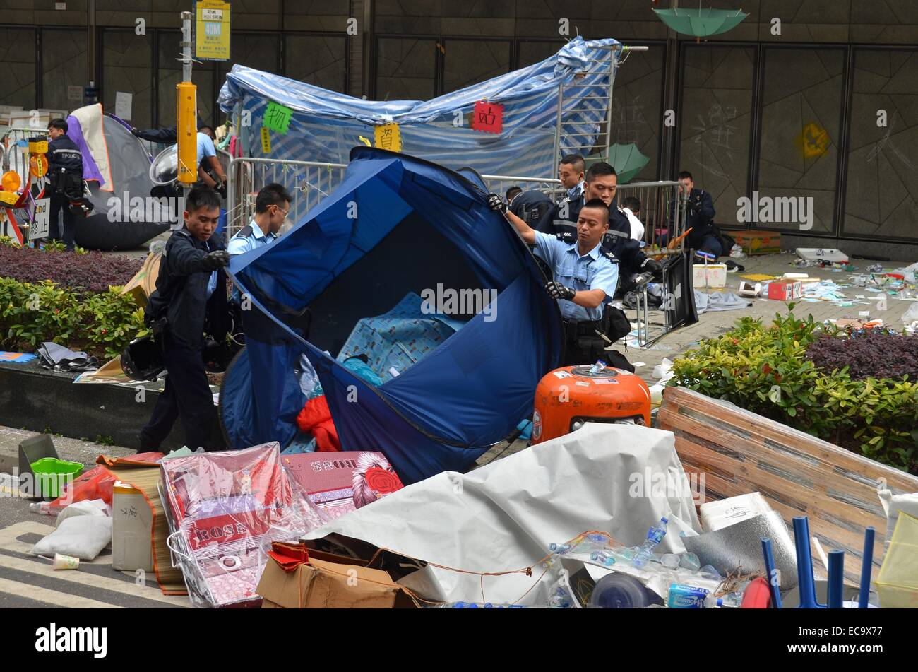 Hong Kong, China. 11th December, 2014. After 74 days of the Occupy Hong Kong protest, police enact a court injunction to remove protesters and their encampment from Connaught Road Central. The authorities had warned protesters to leave in advance of the clearance, but a few pro-democracy demonstrators remained, leading to a handful of arrests. Credit:  Stefan Irvine/Alamy Live News Stock Photo