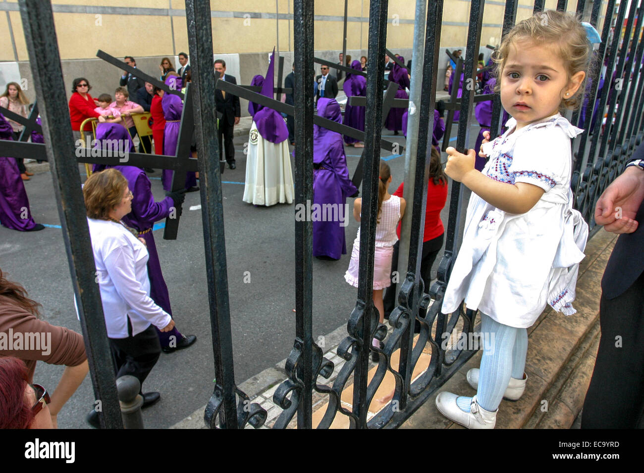 Semana Santa Seville Spain little girl looks at the procession Stock Photo