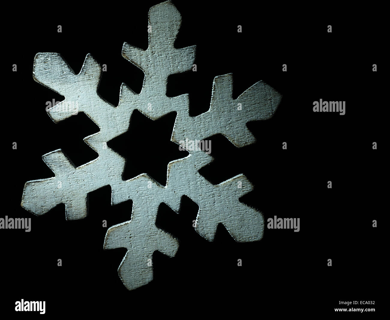 Huge white wooden snowflake and black background Stock Photo - Alamy