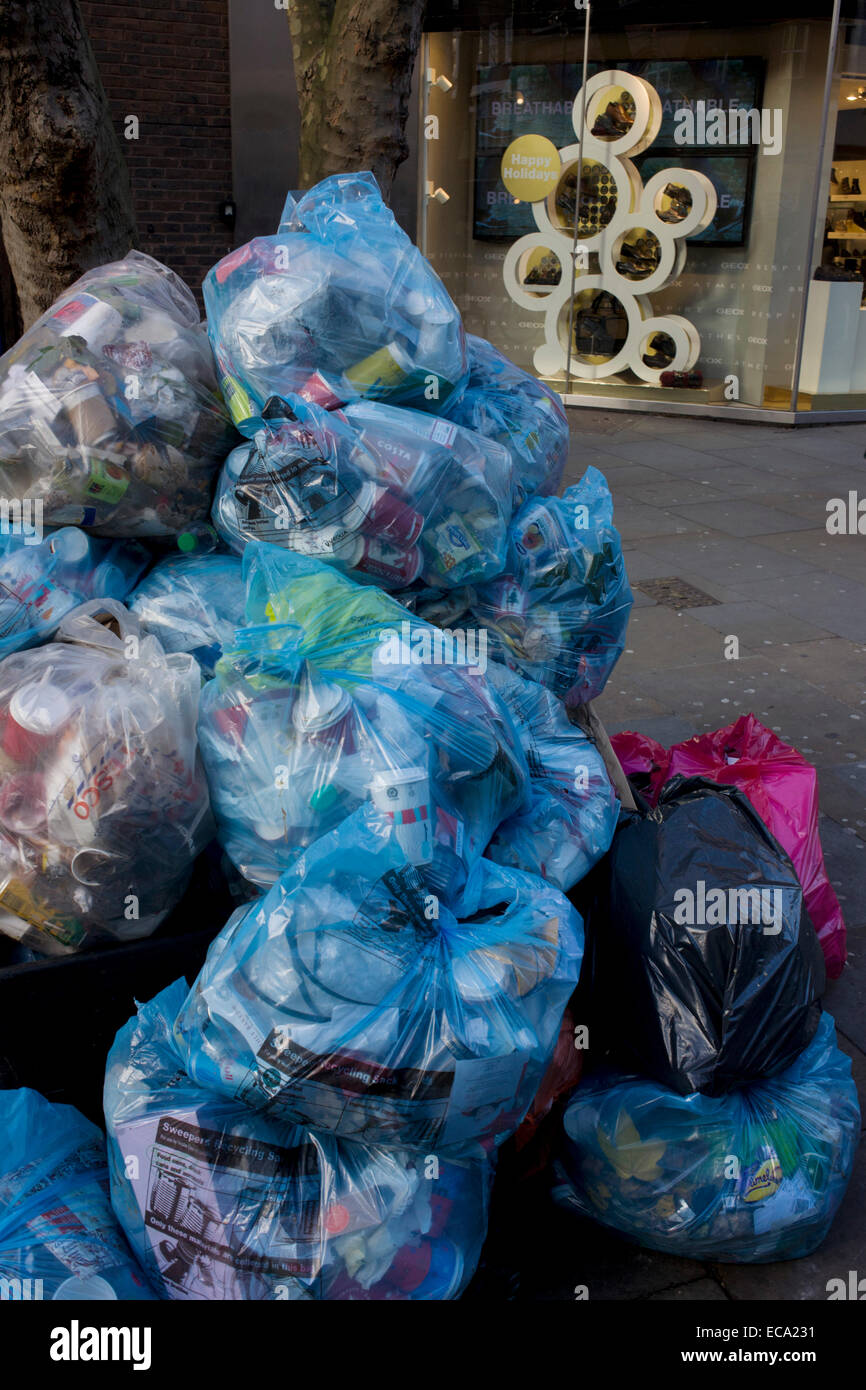 Piles of rubbish bags awaiting collection by council refuse collectors