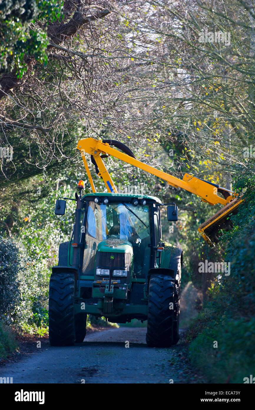 tractor hedge cutting trimming country lane Stock Photo
