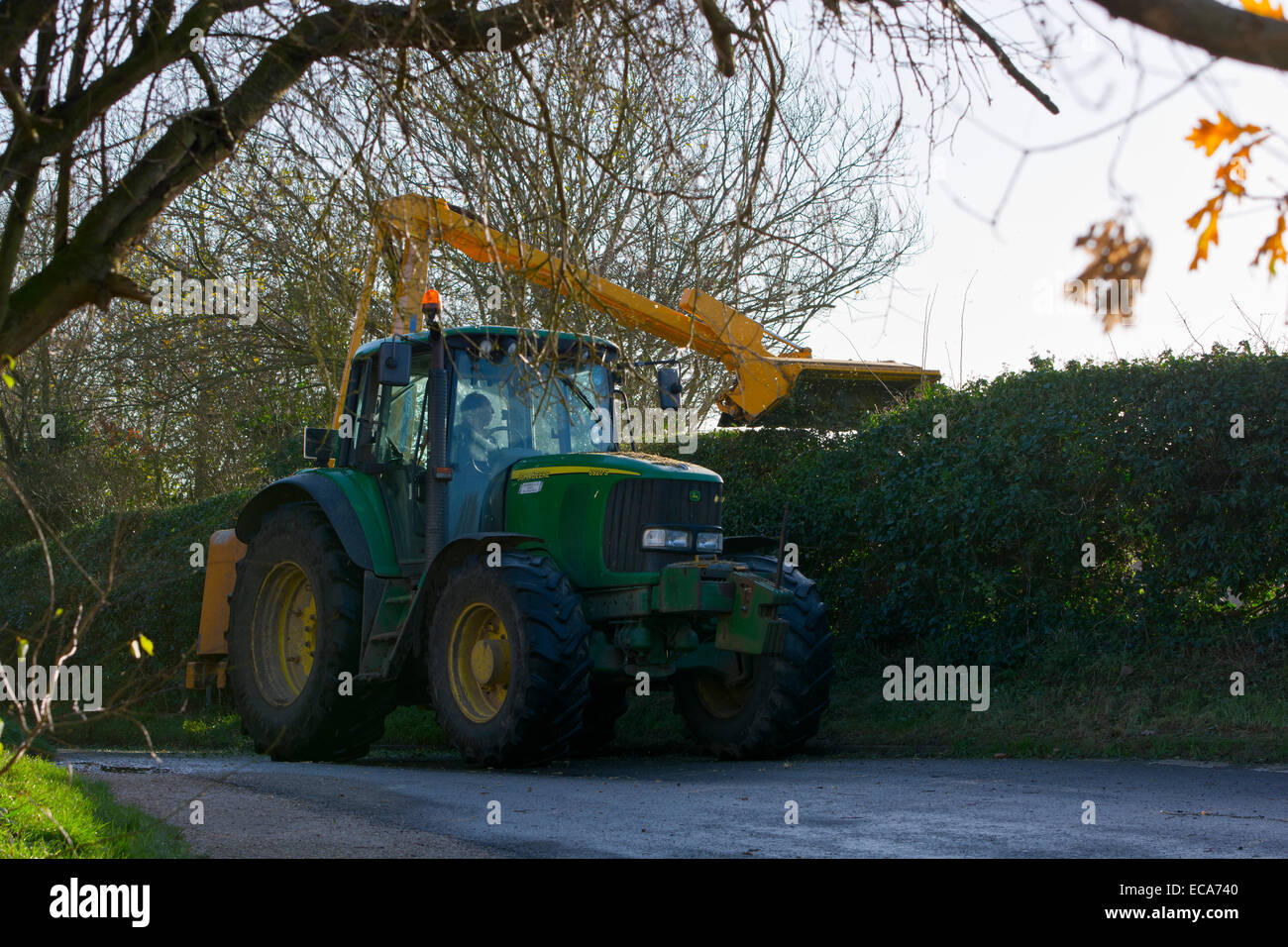 tractor hedge cutting trimming country lane Stock Photo