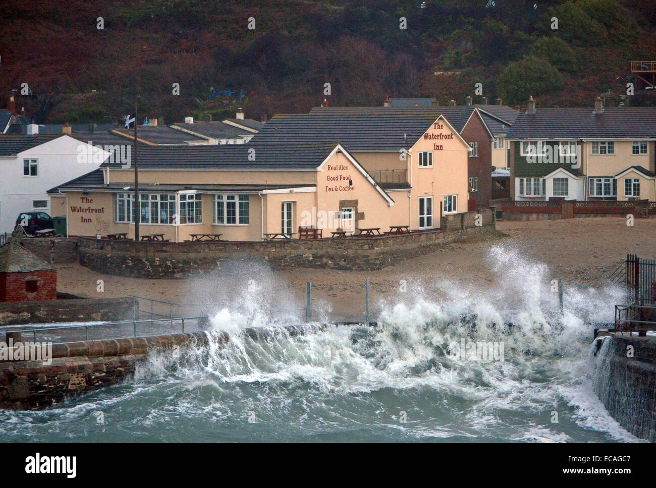 Portreath, Cornwall, UK. 11th December, 2014. UK Weather: High winds and huge waves hit the coast of Cornwall, The sea defences are just holding out against the huge waves and tidal surges . Stock Photo