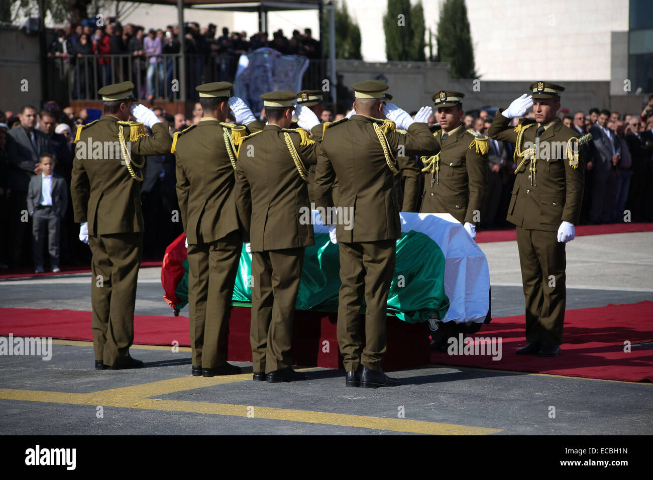 (141211) -- RAMALLAH, Dec. 11, 2014 (Xinhua) -- Palestinian honor guard salutes by the coffin during the funeral procession of the late Palestinian cabinet member Ziad Abu Ain at the Palestinian Authority headquarters in the West Bank city of Ramallah, on Dec. 11, 2014.   (Xinhua/Fadi Arouri) Stock Photo