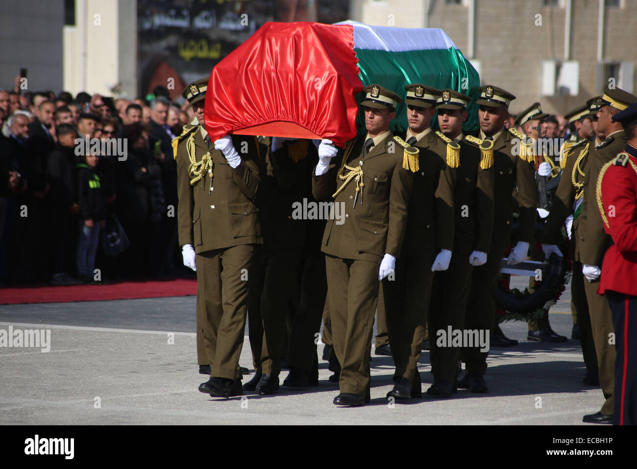 (141211) -- RAMALLAH, Dec. 11, 2014 (Xinhua) -- Palestinian honor guard carries the coffin during the funeral procession of the late Palestinian cabinet member Ziad Abu Ain at the Palestinian Authority headquarters in the West Bank city of Ramallah on Dec. 11, 2014. (Xinhua/Fadi Arouri) Stock Photo