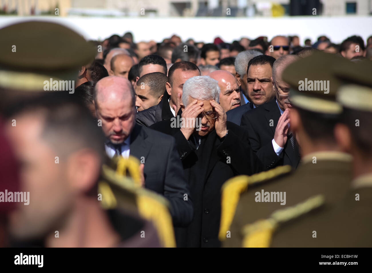(141211) -- RAMALLAH, Dec. 11, 2014 (Xinhua) -- Palestinian President Mahmoud Abbas, center, attends the funeral procession of the late Palestinian cabinet member Ziad Abu Ain at the Palestinian Authority headquarters in the West Bank city of Ramallah on Dec. 11, 2014. (Xinhua/Fadi Arouri) Stock Photo
