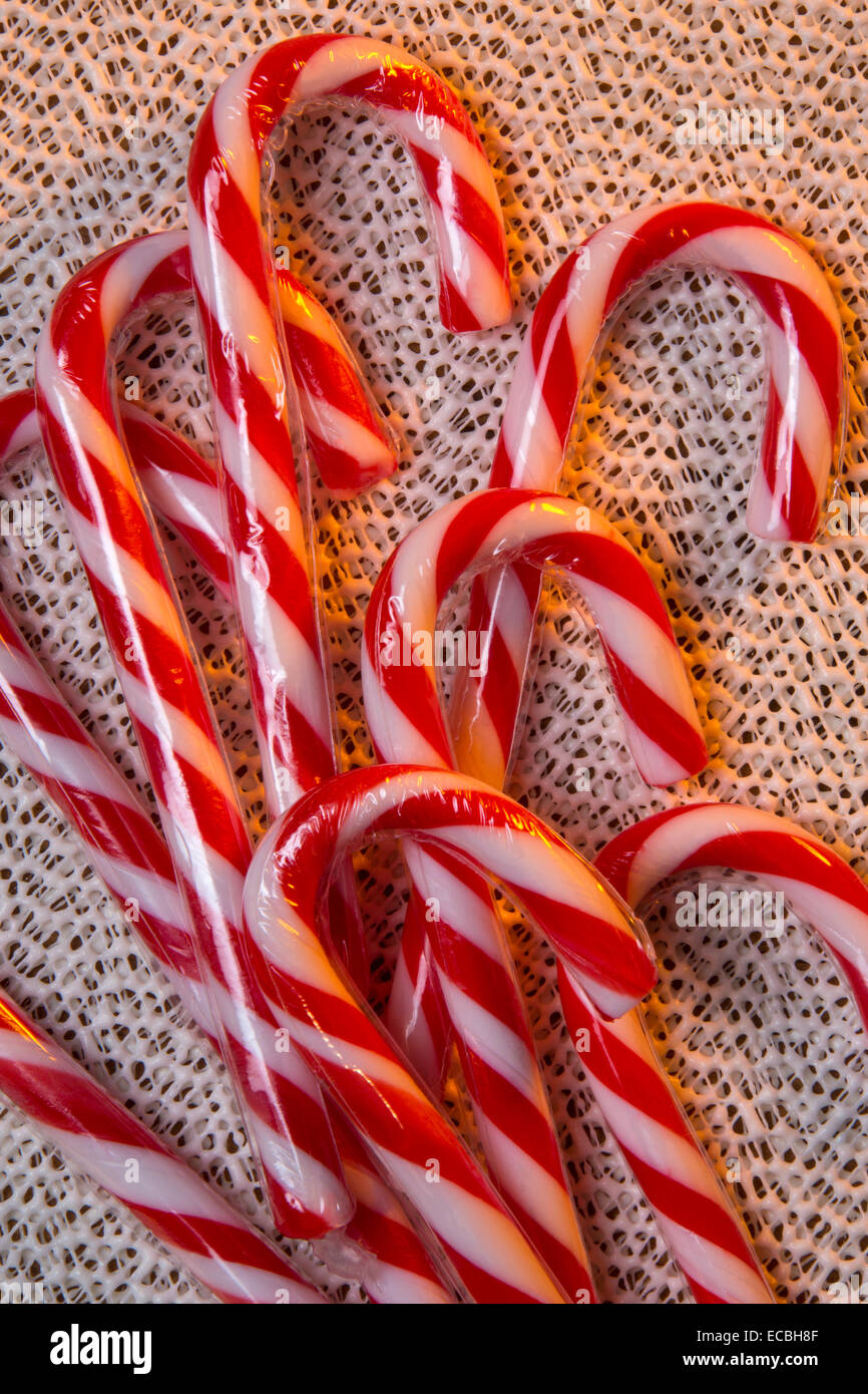 A candy cane or peppermint stick is a cane-shaped hard candy stick associated with Christmas. Stock Photo