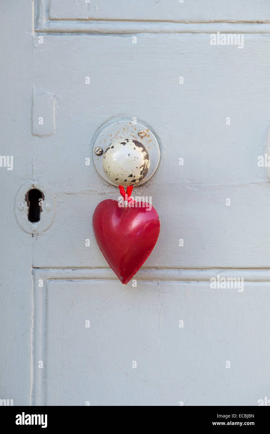 Red heart hanging from a door handle Stock Photo