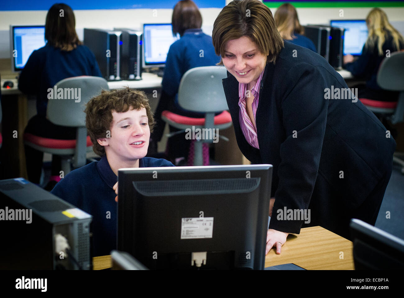 teacher helping student in coding class,UK Stock Photo