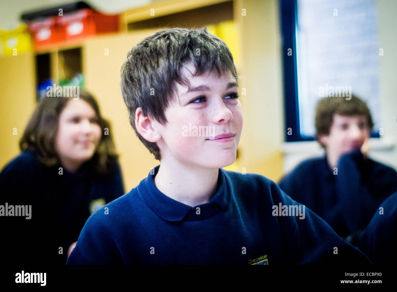 Smiling boy in secondary school class, UK Stock Photo
