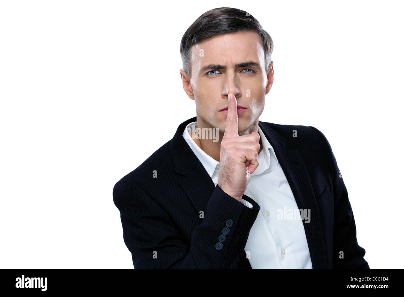 Businessman placing finger on lips saying shhh, be quiet! Stock Photo