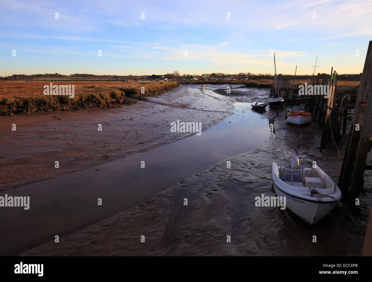 Wooden jetties and boats in the harbour at Morston on the North Norfolk coast. Stock Photo