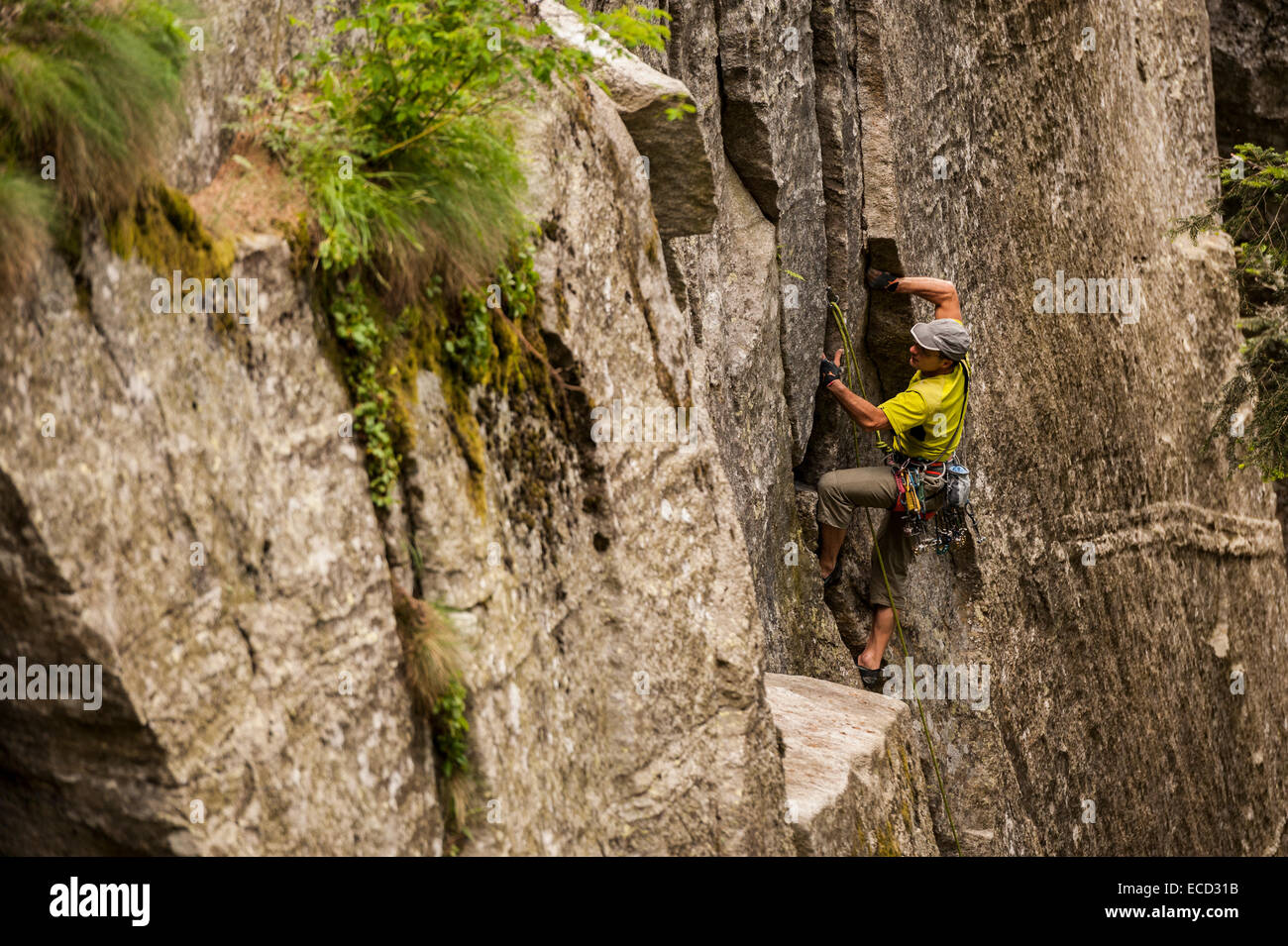 Man trad climbing a crack route in Esigo, Ossola, Italy. Ossola is one of the main destination in Europe for crack climbing. Stock Photo