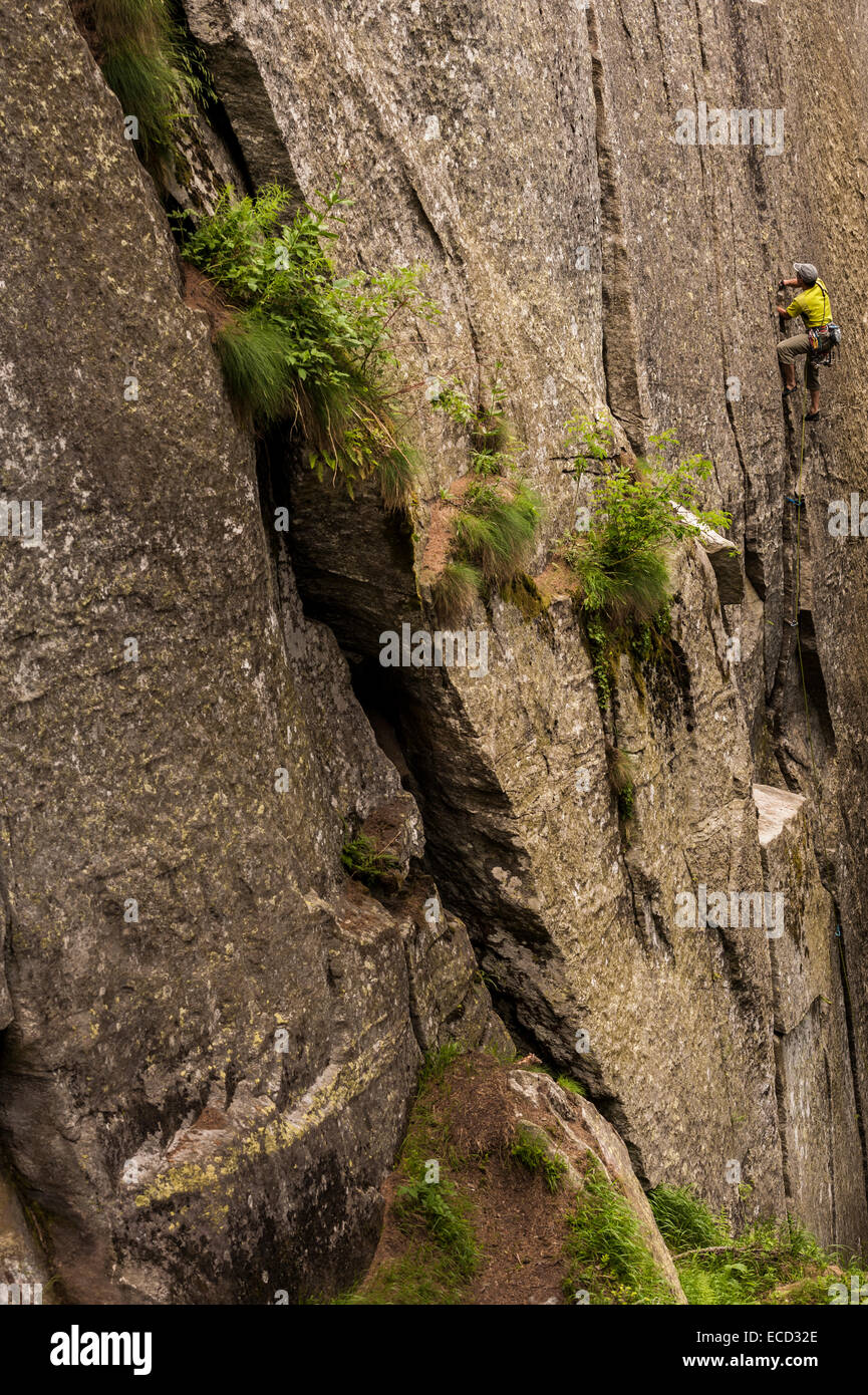 Man trad climbing a crack route in Esigo, Ossola, Italy. Ossola is one of the main destination in Europe for crack climbing. Stock Photo