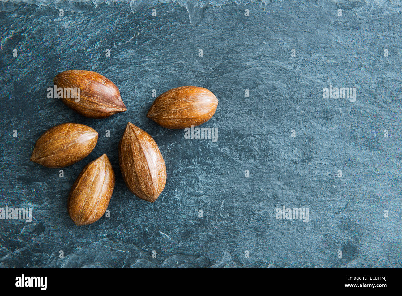 Closeup on pecans on stone substrate Stock Photo