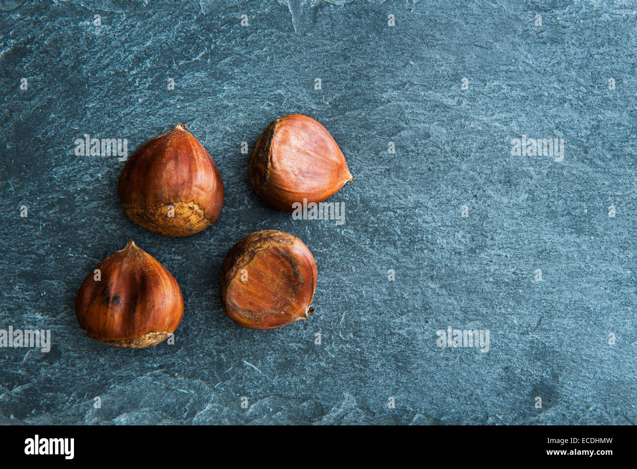 Closeup on chestnuts on stone substrate Stock Photo