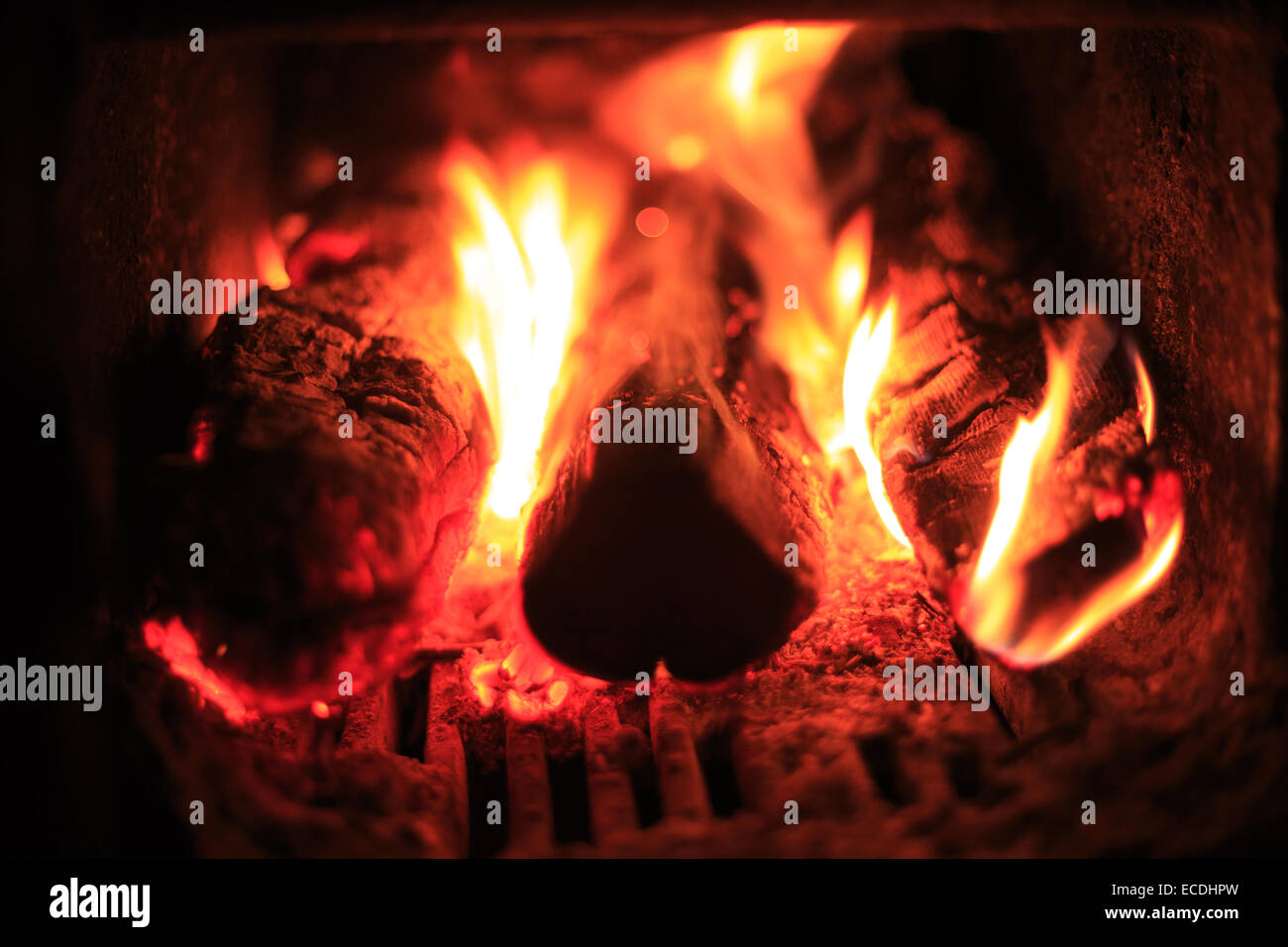 Fire place abstract background - closeup of bright blaze flare and firewood Stock Photo