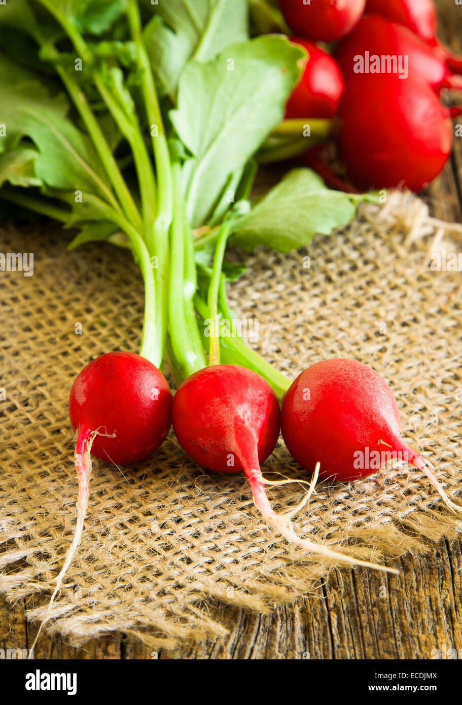 Bunch of fresh radish on wooden table Stock Photo