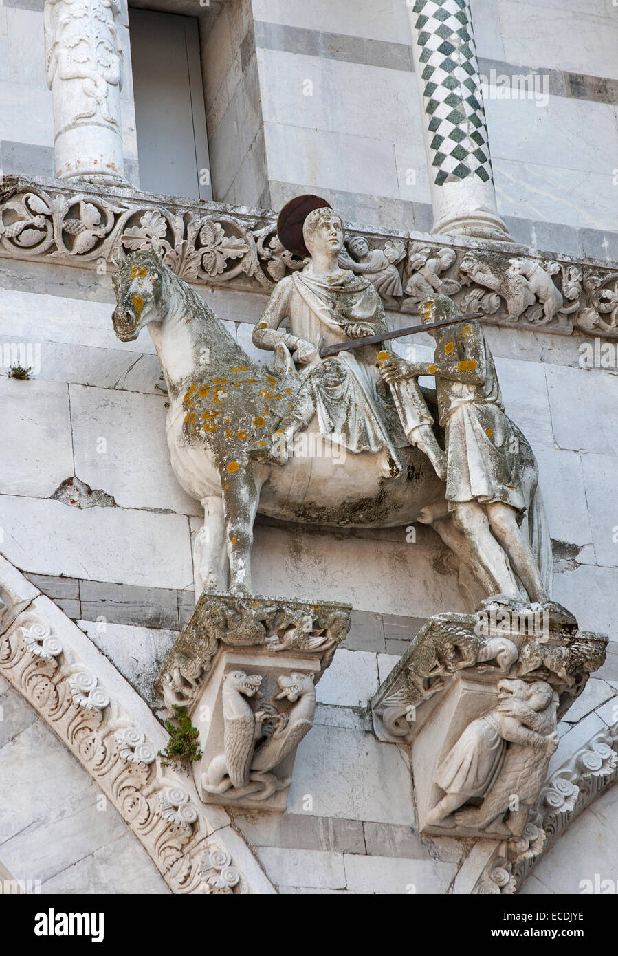 The scene of St. Martin dividing his cloak into two parts and giving one to the poor man on the facade of the Cathedral of St Ma Stock Photo