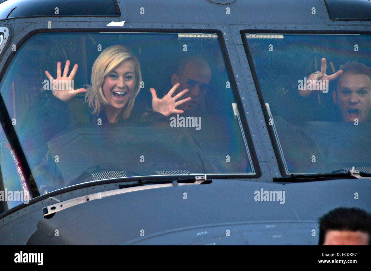 Singer Kellie Pickler and her husband, Kyle Jacobs wave from inside a CV-22 Osprey Aircraft as they arrive to perform for US service members as part of the USO holiday tour at Royal Air Force Mildenhall December 10, 2014 in Mildenhall, England. This was Pickler’s eighth USO tour. Stock Photo