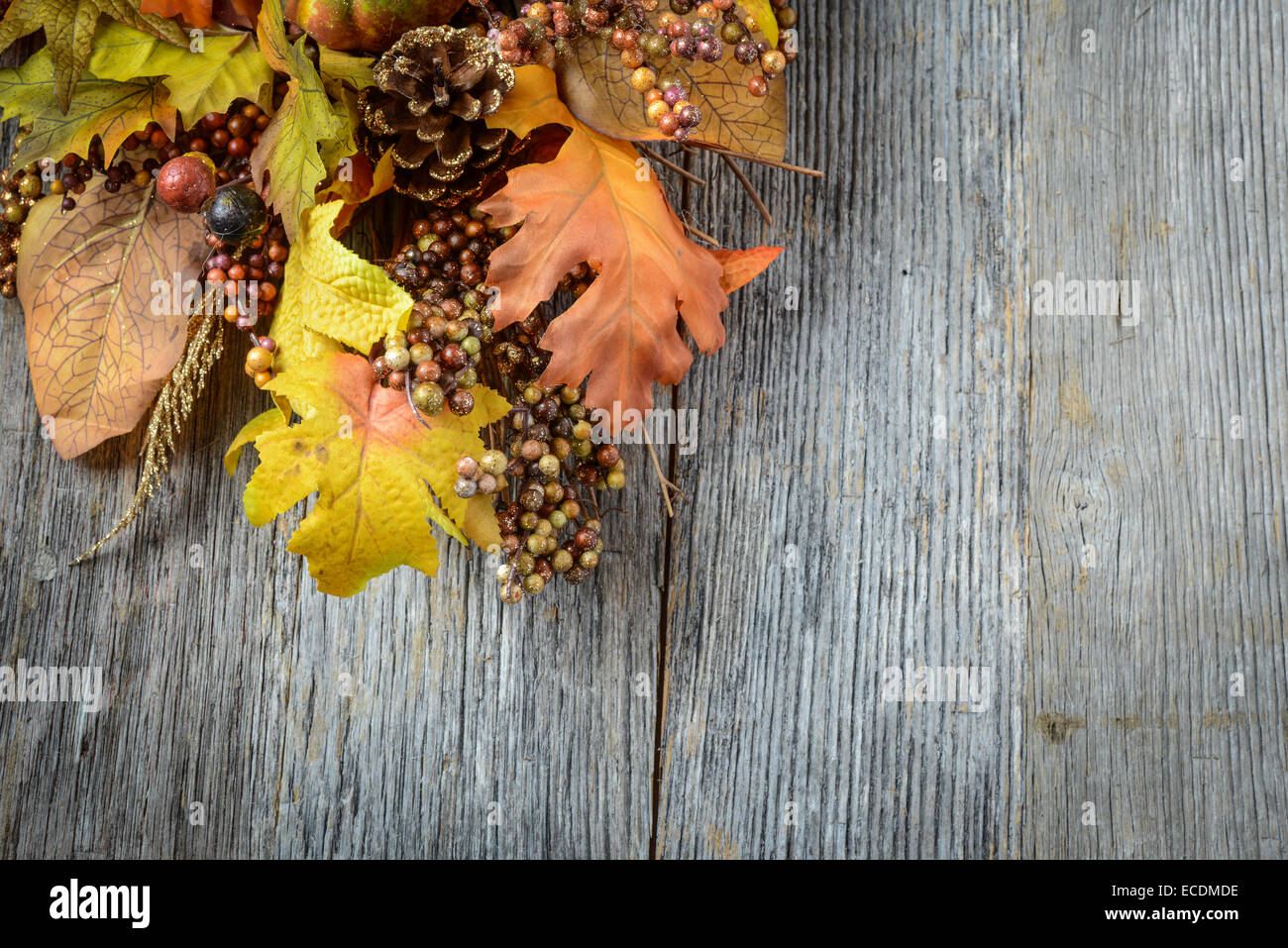 Autumn leaves and berry over wooden background for Thanksgiving Stock Photo