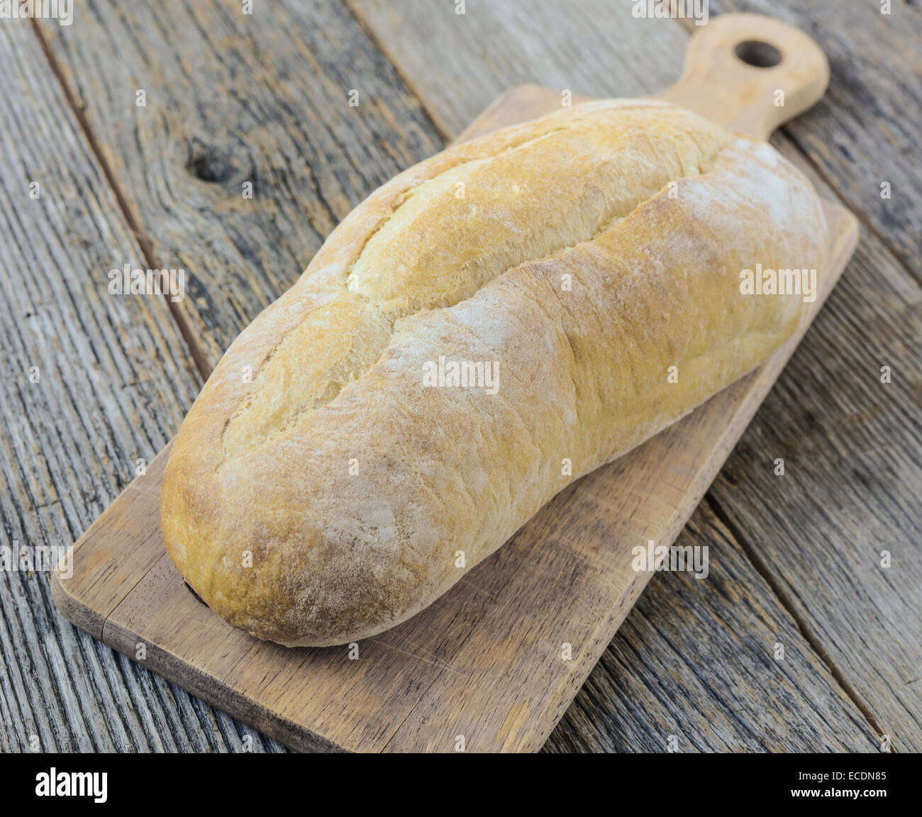 Bread on a Bread Board with Rustic Wood Background Stock Photo - Alamy