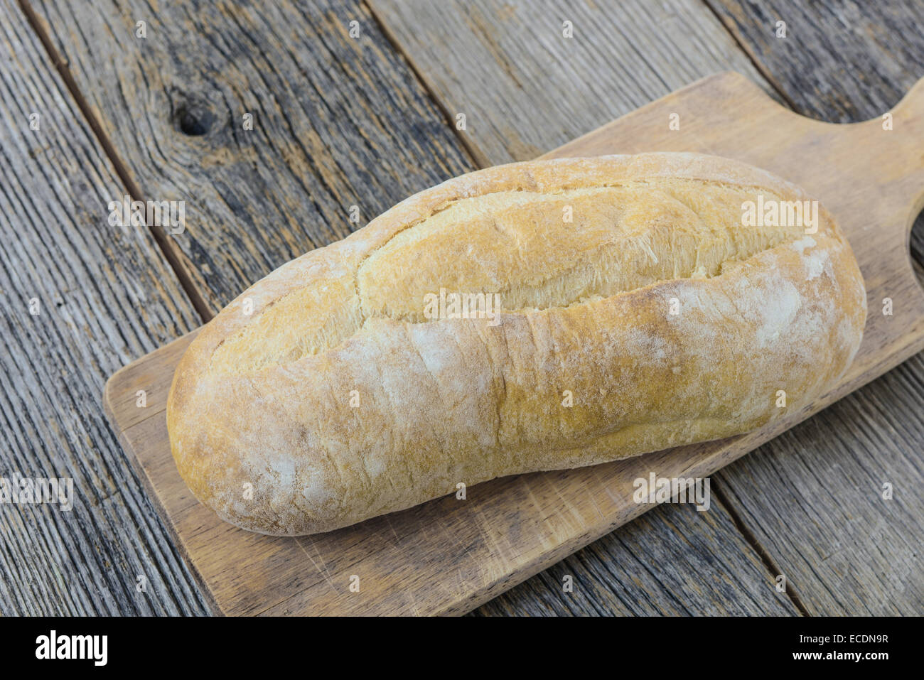 Bread on a Bread Board with Rustic Wood Background Stock Photo - Alamy