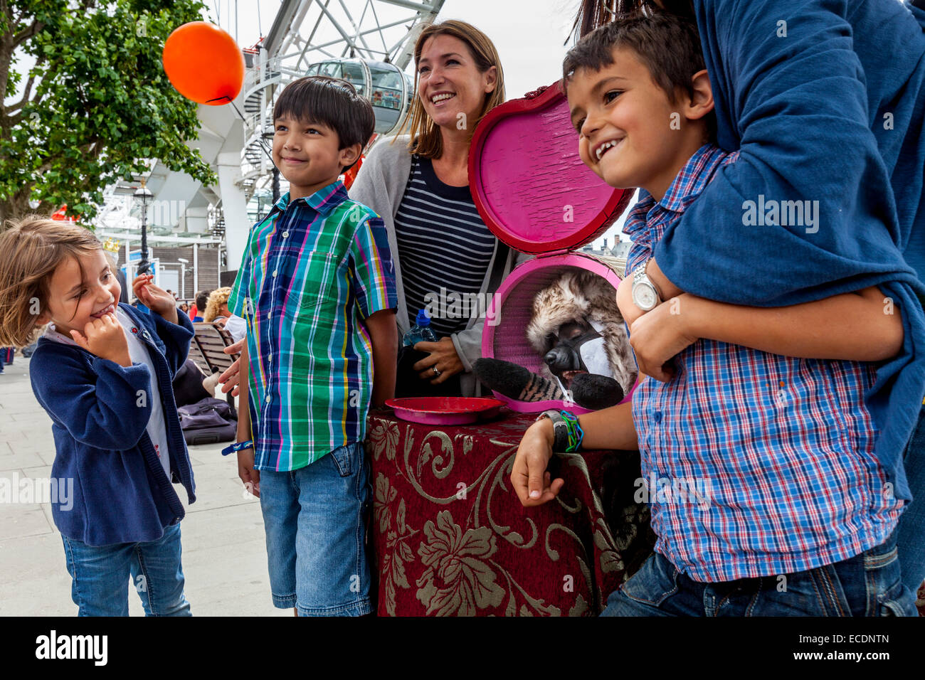 A Family Poses With A Street Entertainer At The South Bank, London, England Stock Photo