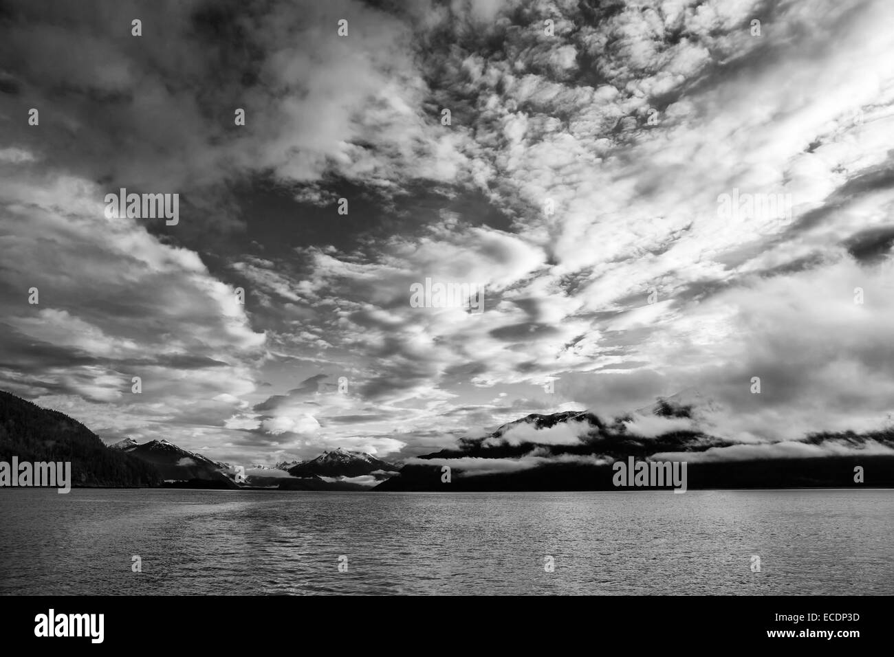 Dramatic clouds at sunset in Southeast Alaska in black and white Stock ...