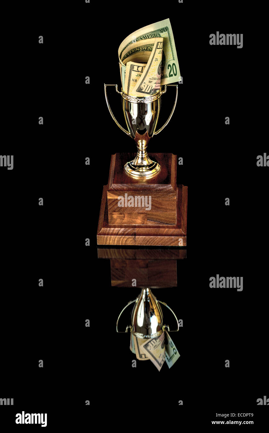 Trophy cup and reflection filled with money Stock Photo