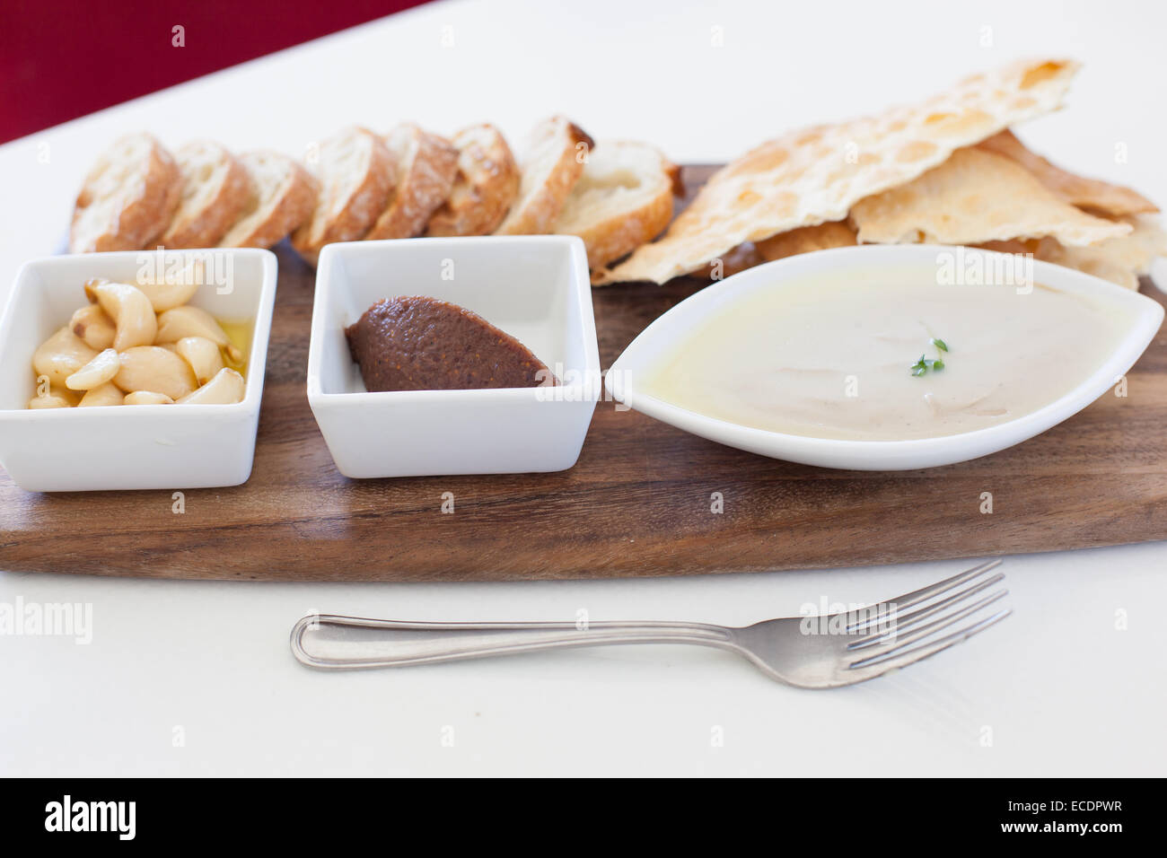 Liver pate plate with bread, fig jam, and garlic confit Stock Photo