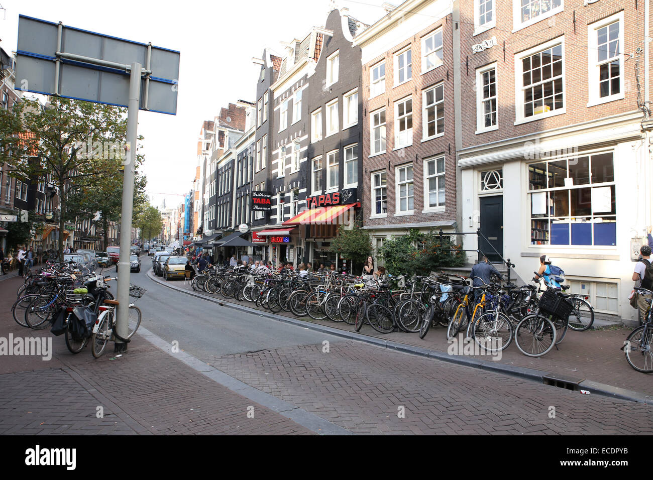 amsterdam narrow road bikes cafes Stock Photo Alamy