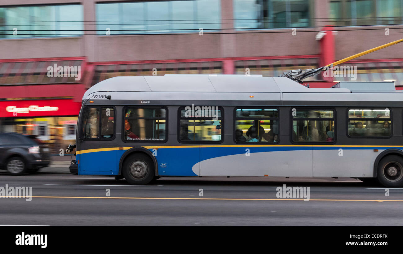 profile view motion blur commuters on board a public transit trolley bus Vancouver Canada Stock Photo