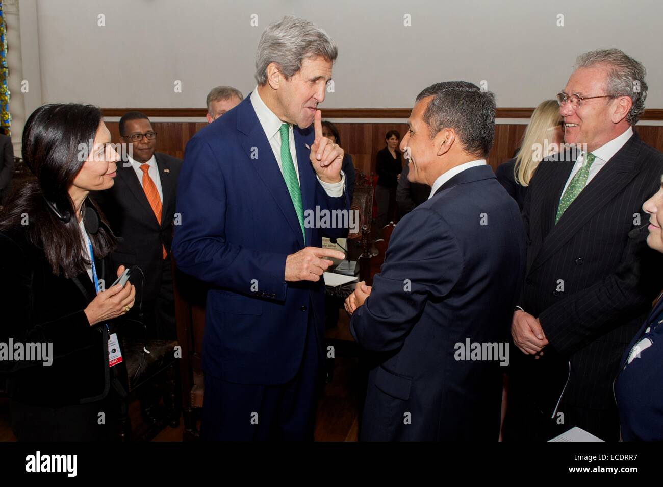 US Secretary of State John Kerry jokingly tells President Ollanta Humala of Peru not to mention his age after the President congratulated him on his 71st birthday before their bilateral meeting December 11, 2014 in Lima, Peru. Stock Photo