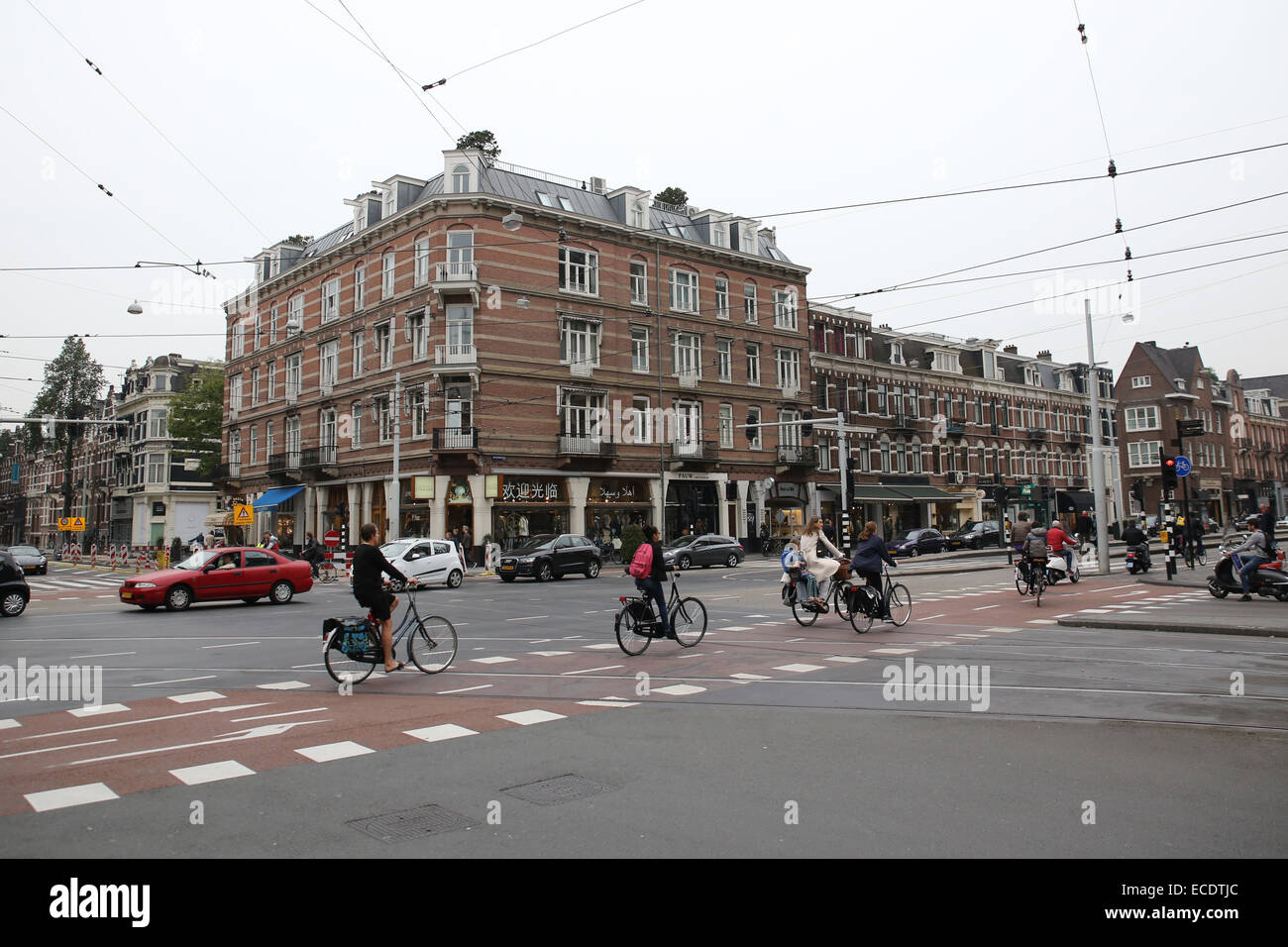 Amsterdam people biking cycling road city street bike lane Stock Photo