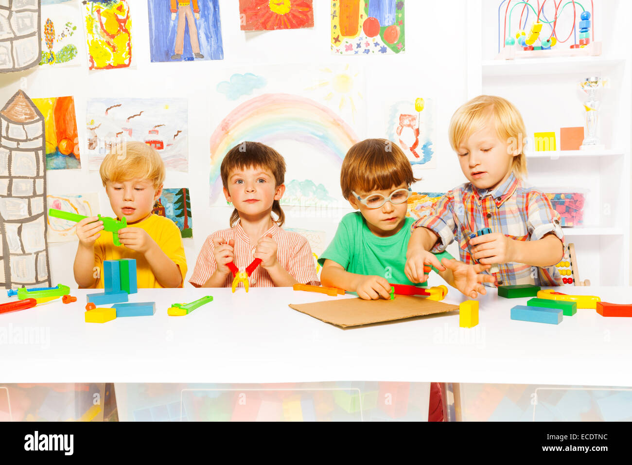 Boys learn to use tools as grownups Stock Photo