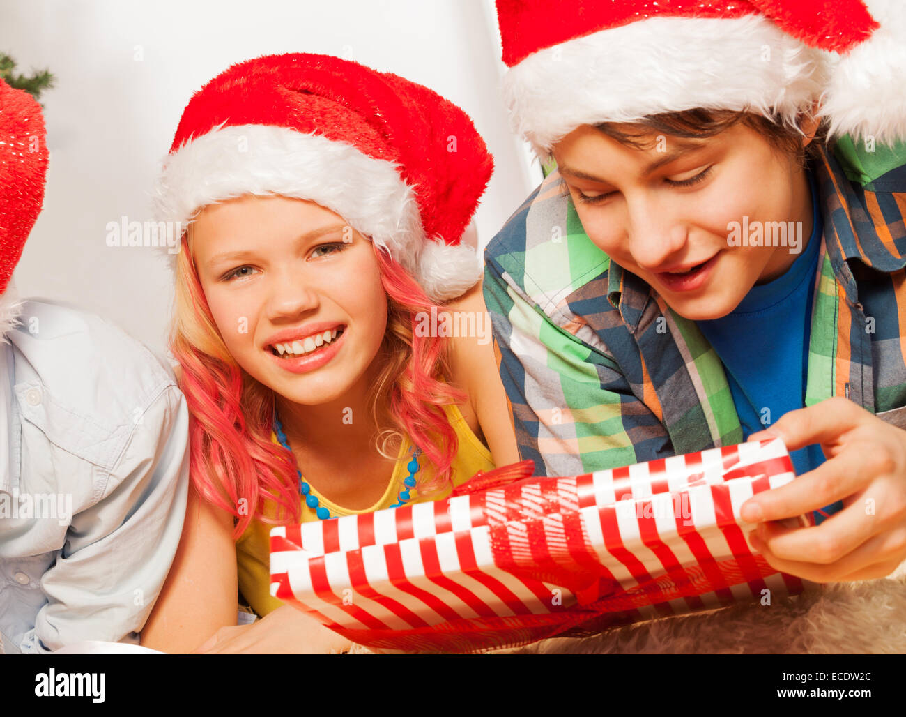 Happy kids in Santa New year hats and with present Stock Photo