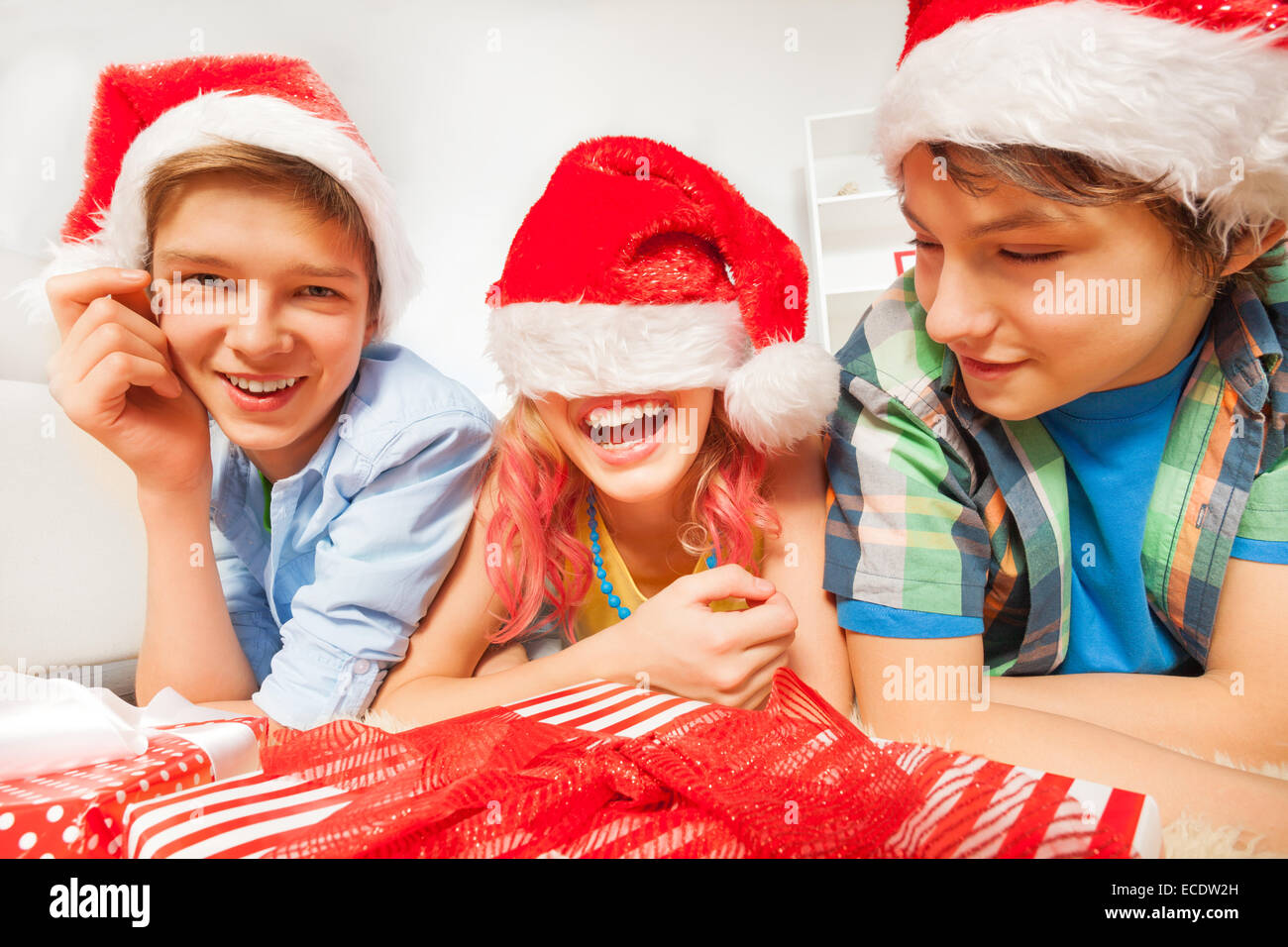 Fun for teens on New year party with Santa hats Stock Photo
