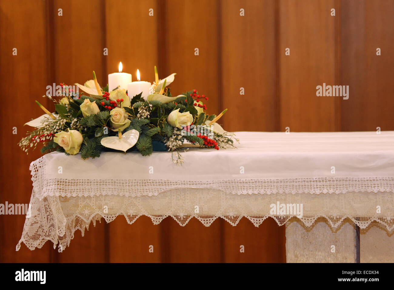 beautiful bouquet of flowers with two lit candles on the altar of the
