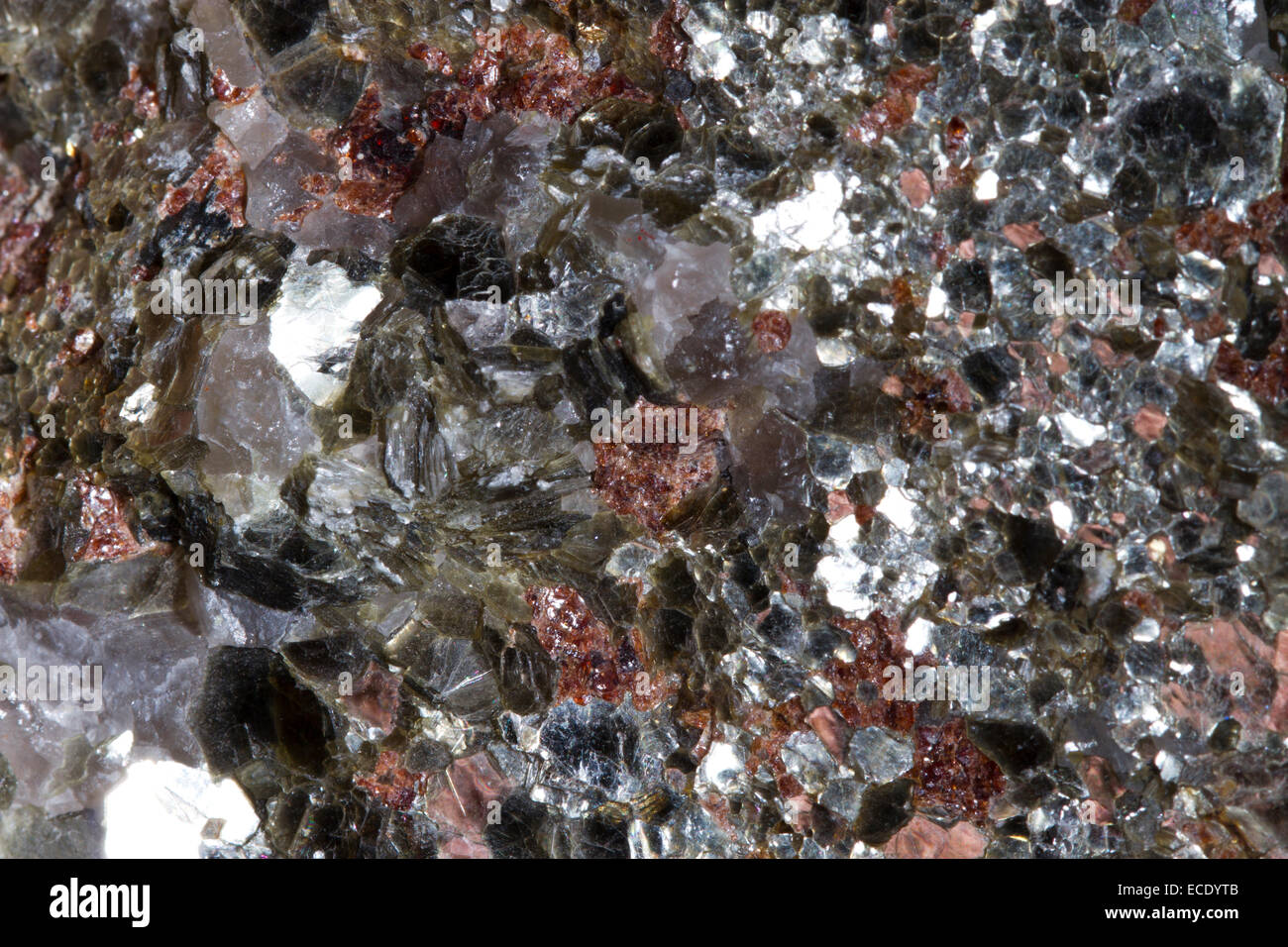Minerals. Muscovite mica flakes, garnets, and quartz. Origin Norway. Stock Photo