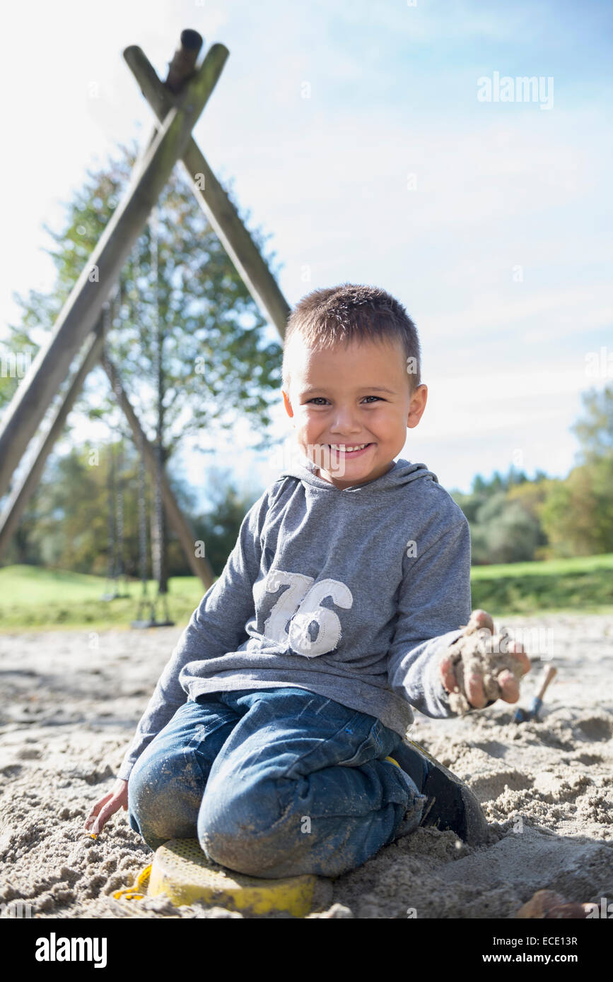 Portrait smiling small boy sandbox playground Stock Photo