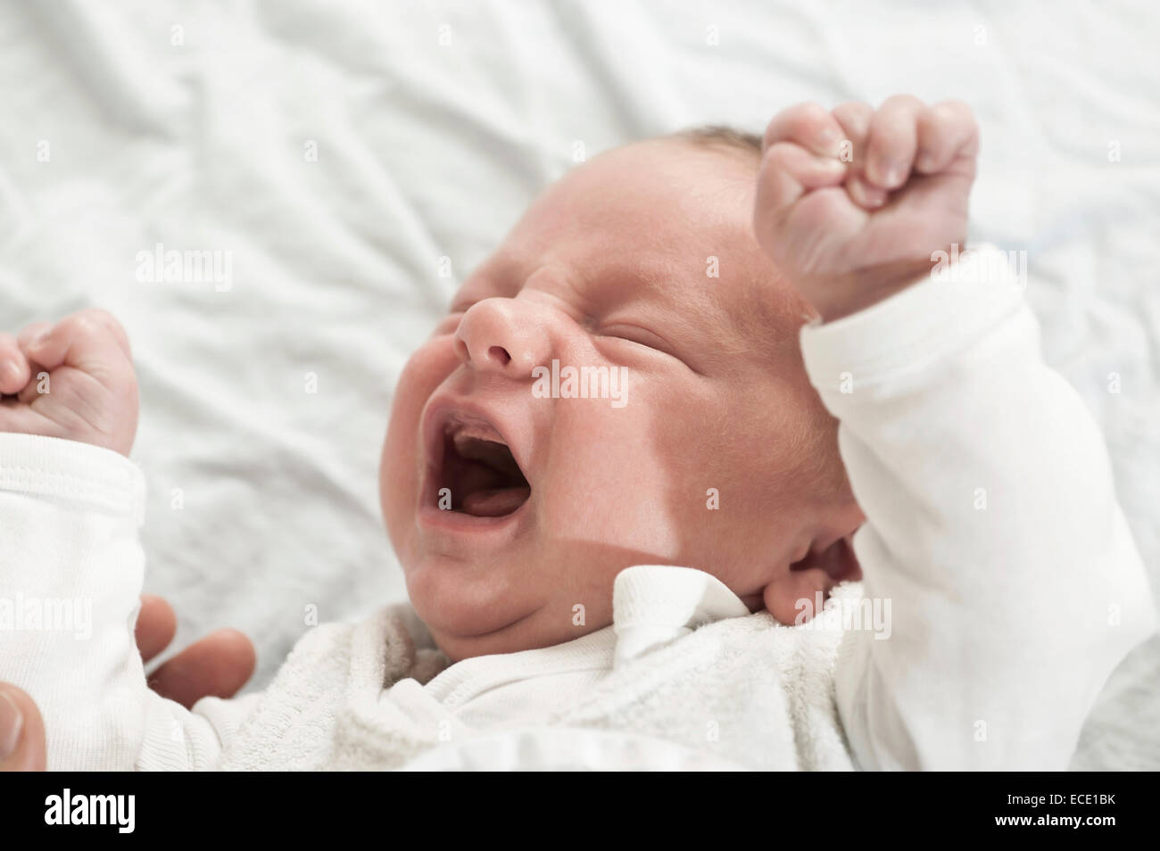 Small baby crying 2 weeks old screaming Stock Photo